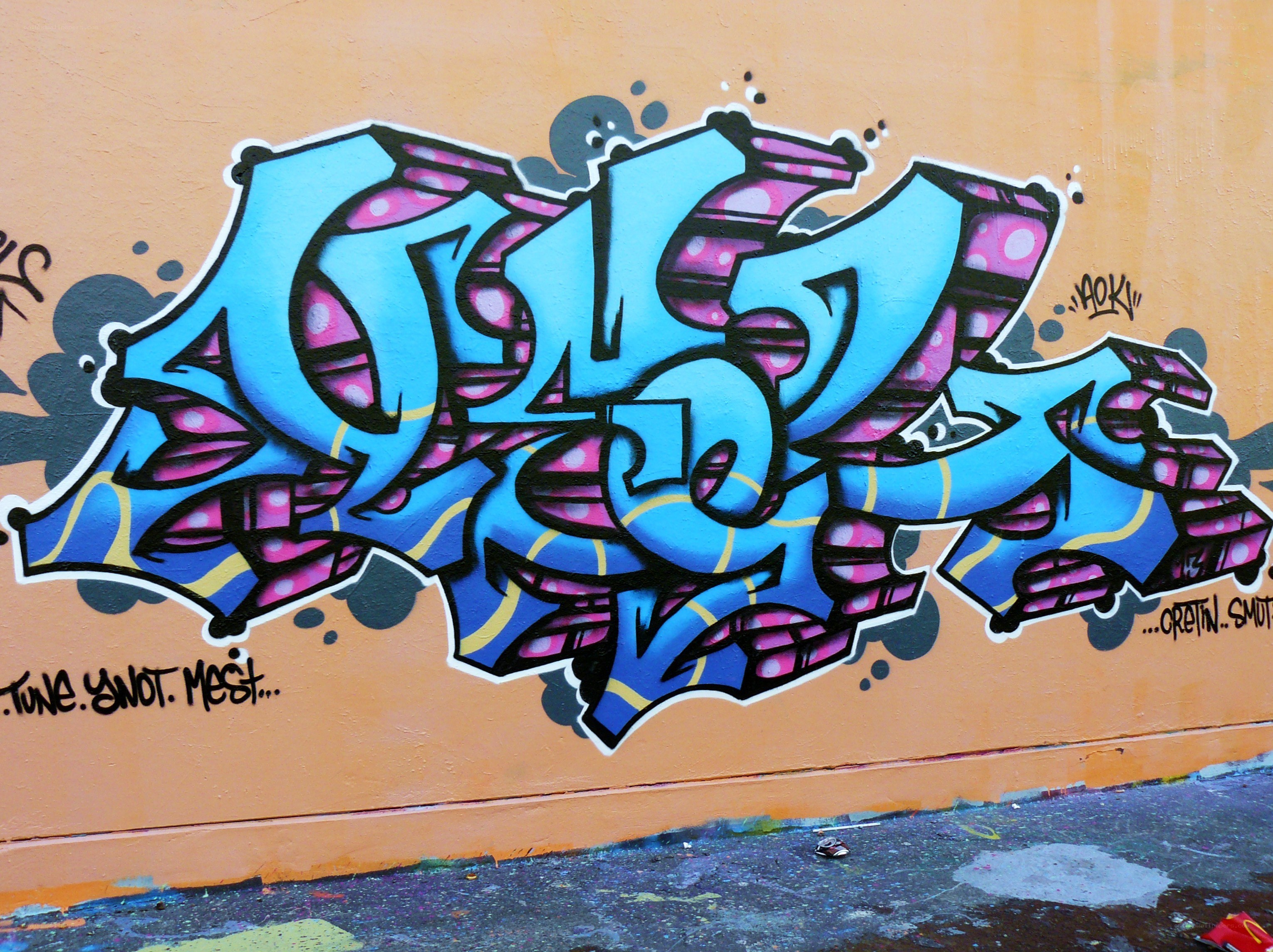 colorful graffiti on orange wall