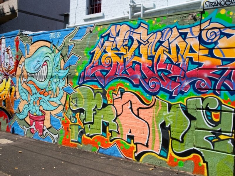 Colorful Graffiti on Wall — Green, Vibrant, Afternoon