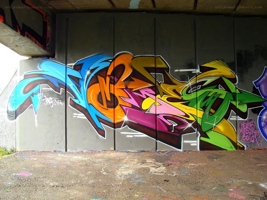 colorful graffiti under bridge