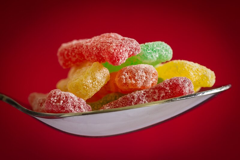 Colorful gummy candies on a spoon