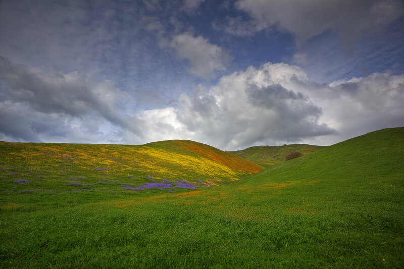 Colorful hills under cloudy sky
