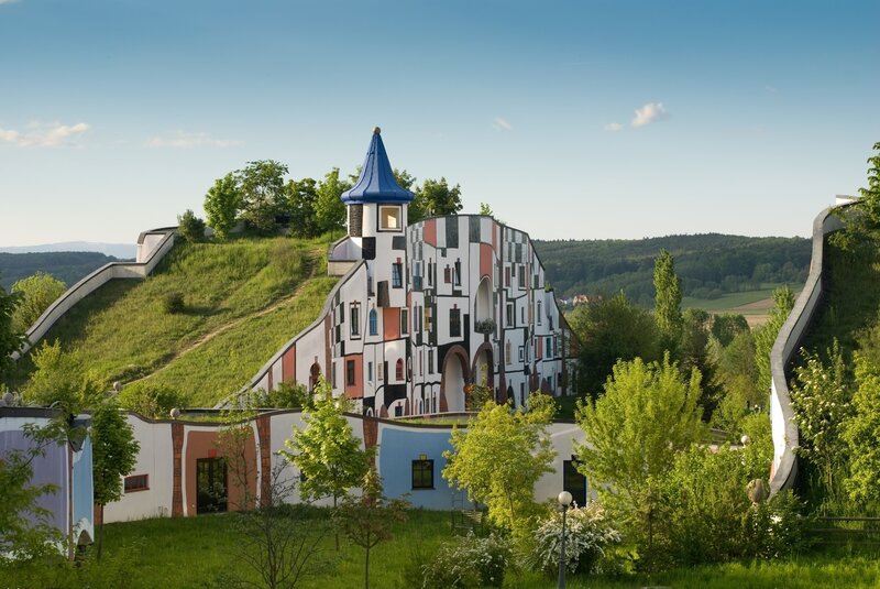 Colorful hillside building with blue spire