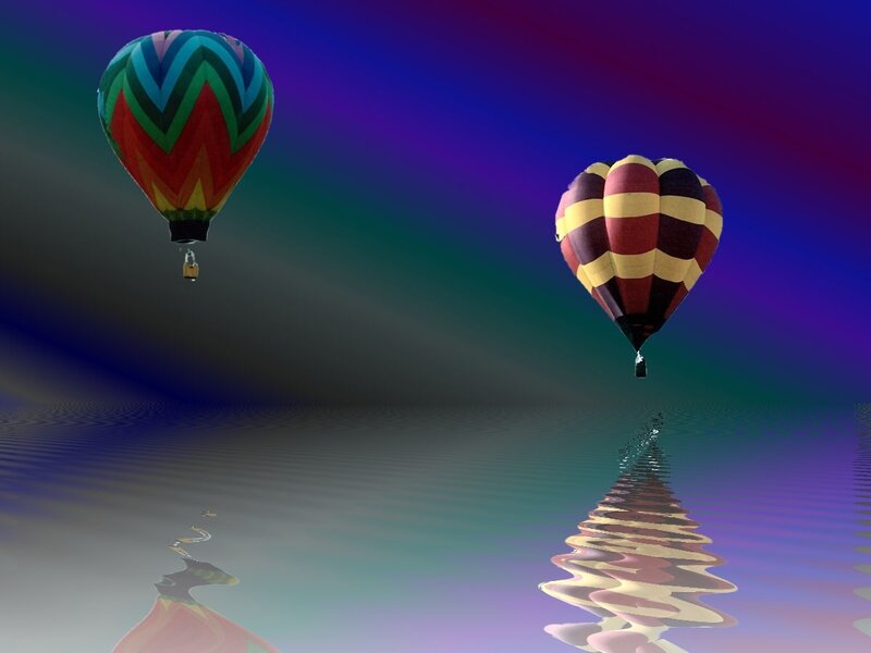 Colorful hot air balloons over water