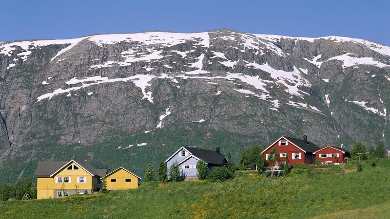 Colorful houses by a snowy mountain