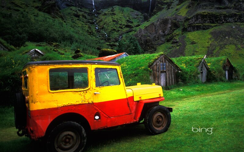 Colorful jeep in a green valley