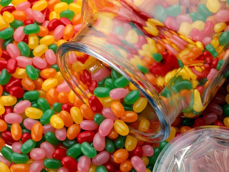 Colorful jelly beans spilling from jar