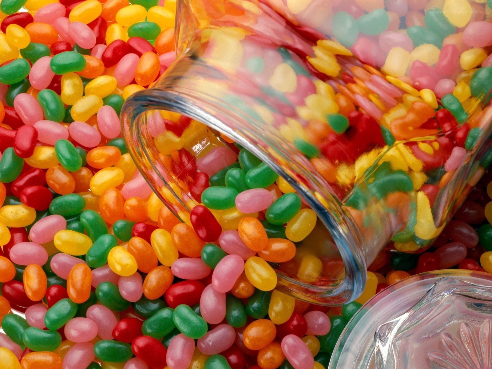 Colorful jelly beans spilling from jar