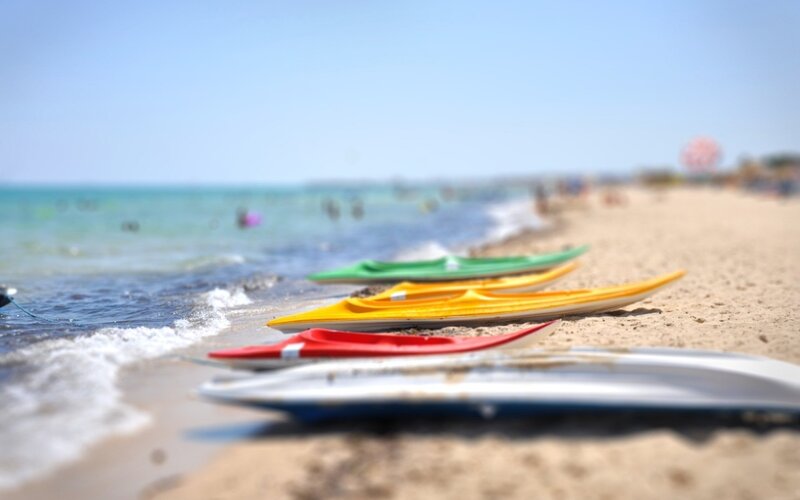 Colorful kayaks on a sunny beach
