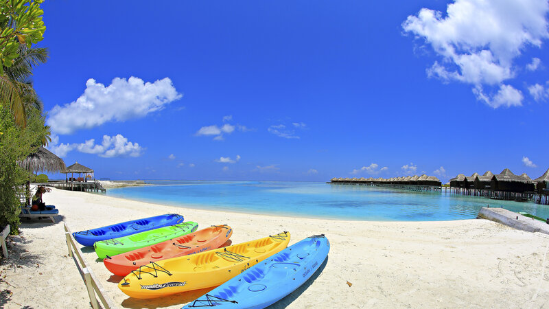 Colorful Kayaks on Beach — Blue, Serene, Afternoon, Photograph