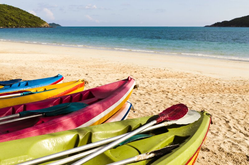 Colorful Kayaks on Beach — Green