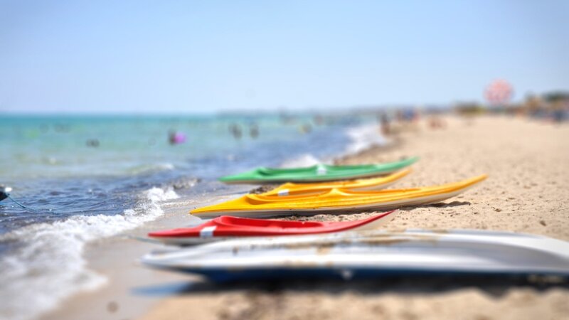 Colorful Kayaks on Beach — Red