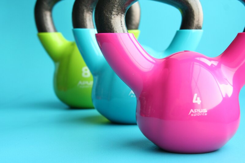 Colorful kettlebells on blue