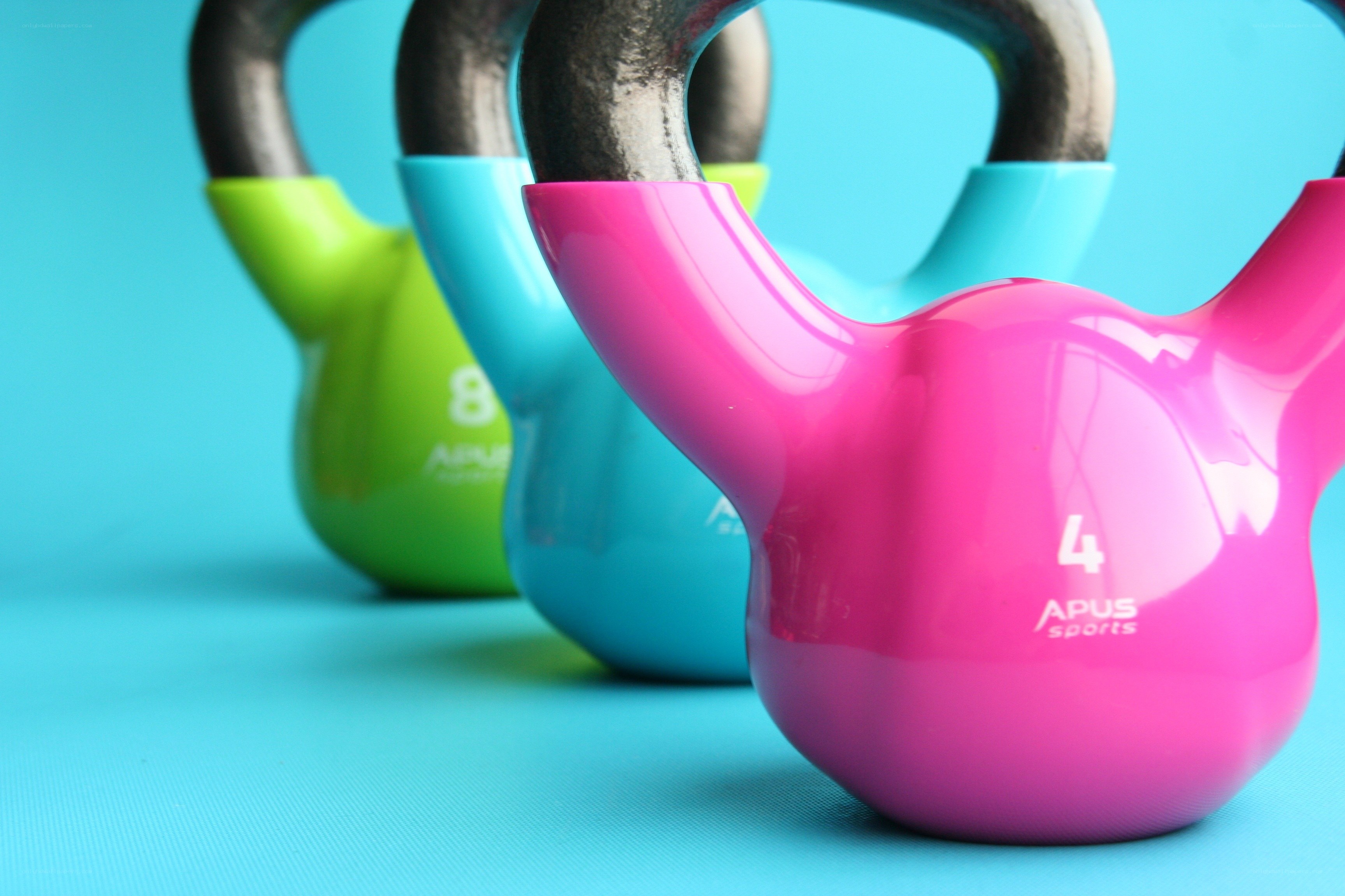 Colorful kettlebells on blue