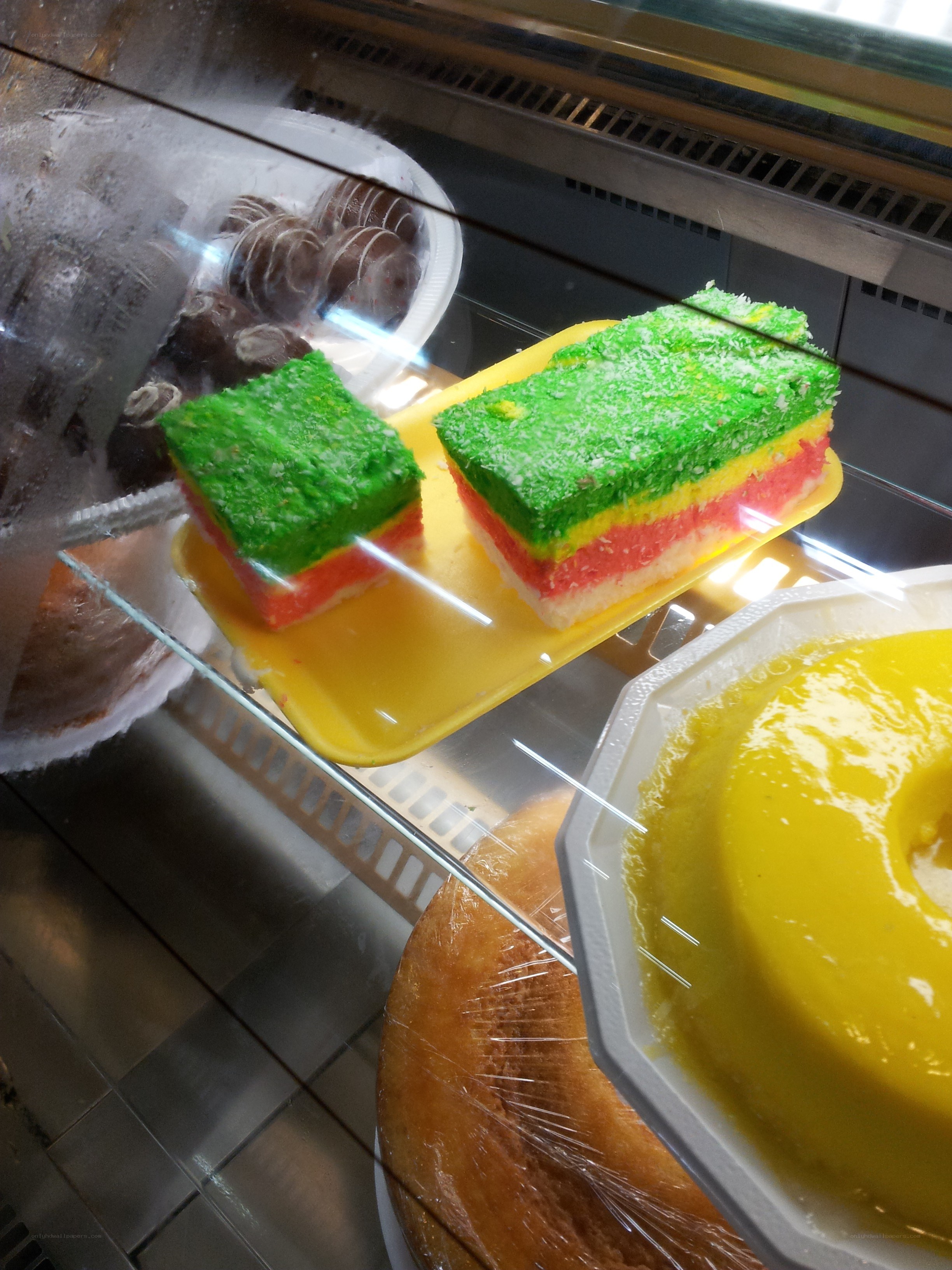 Colorful layered cakes in display