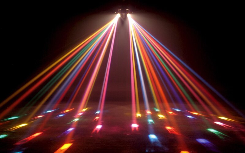 Colorful light beams on dark floor