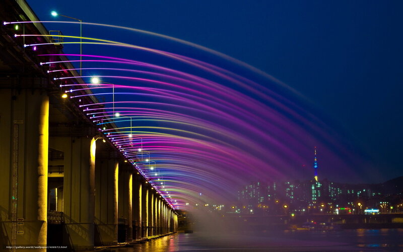 Colorful light show over a bridge