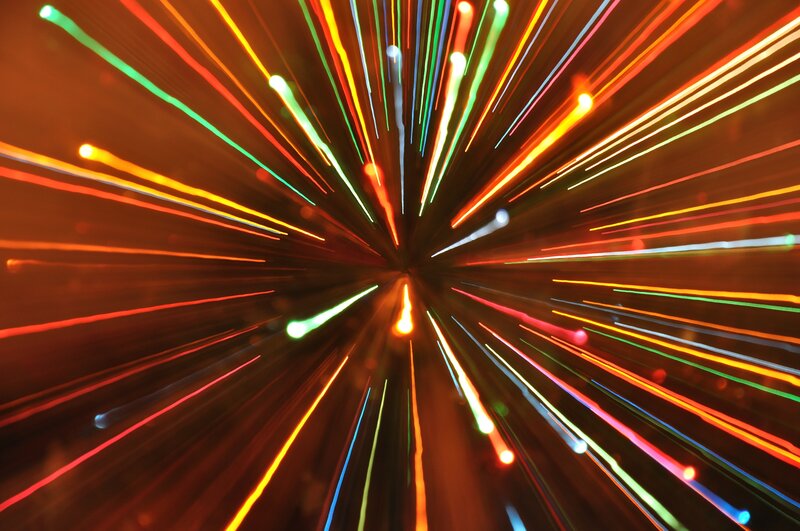 Colorful light streaks radiating outward