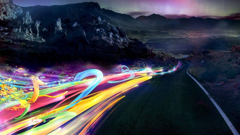 Colorful light trails on a desert road