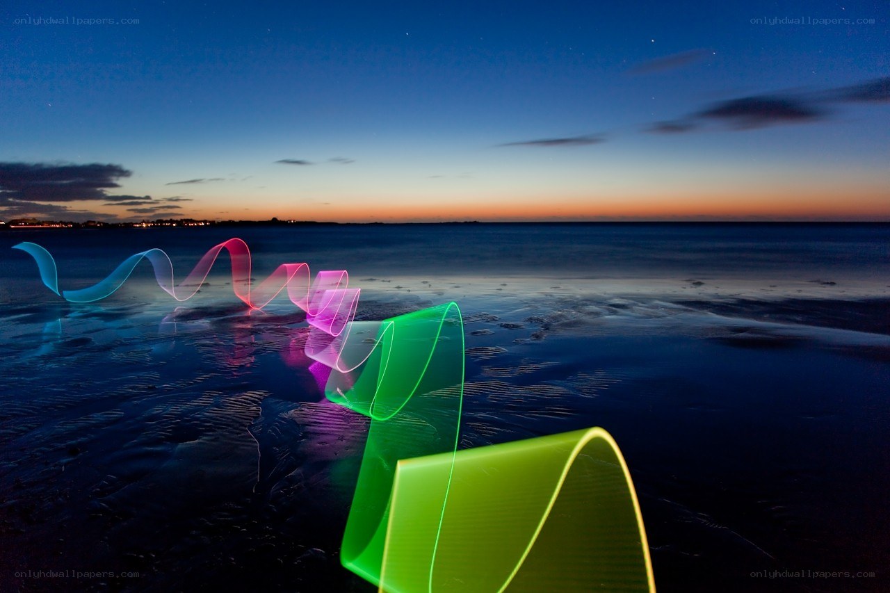 Colorful light trails on beach