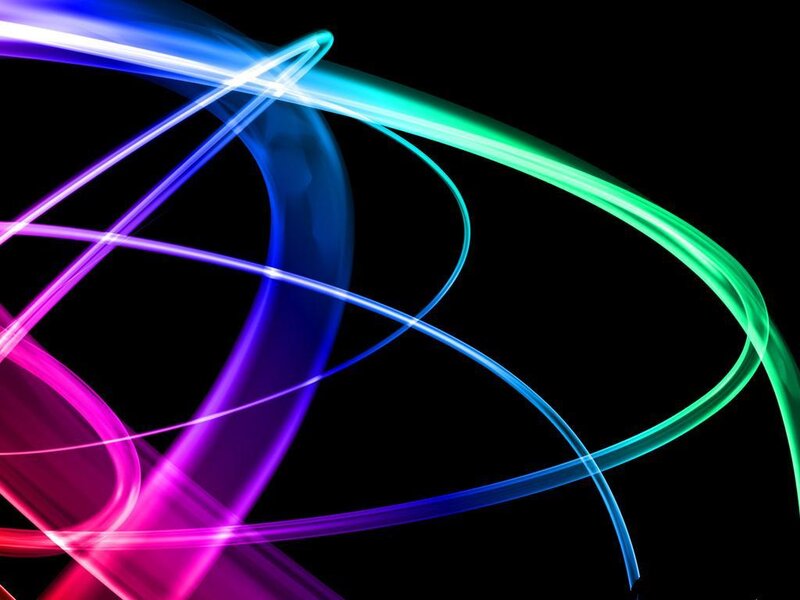 colorful light trails on black