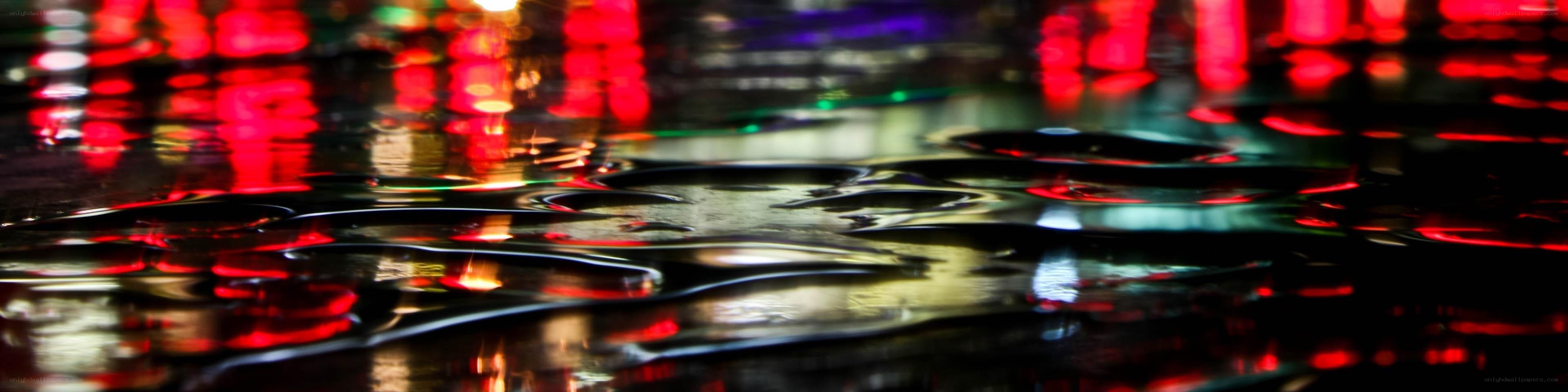 Colorful lights on wet pavement