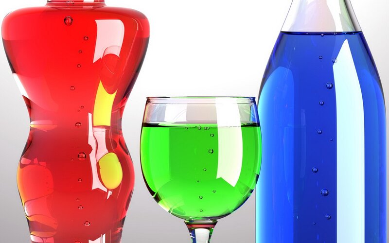 Colorful liquid bottles and glass