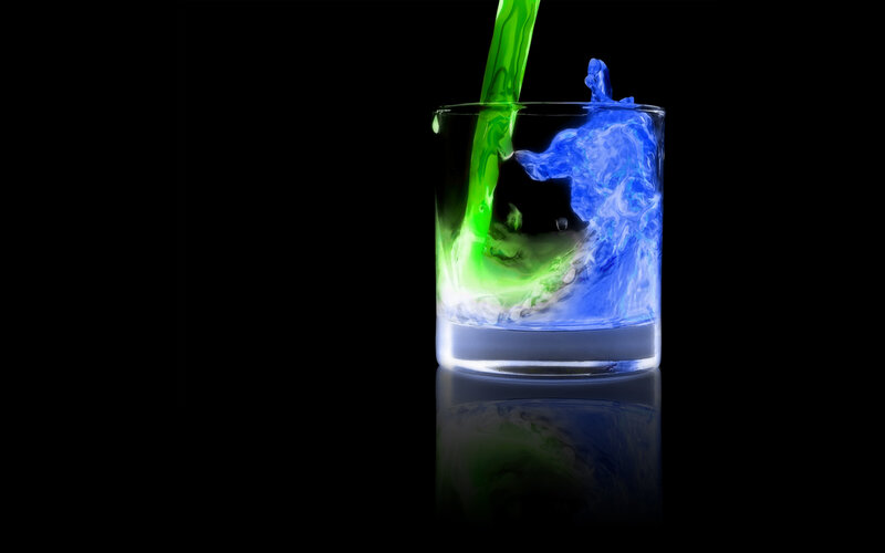 Colorful liquid pouring into glass