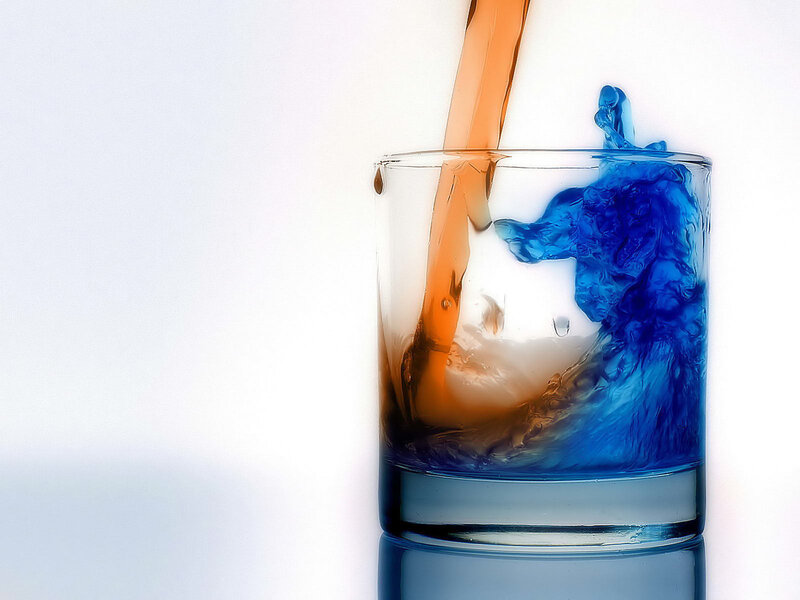 Colorful liquid pouring into glass