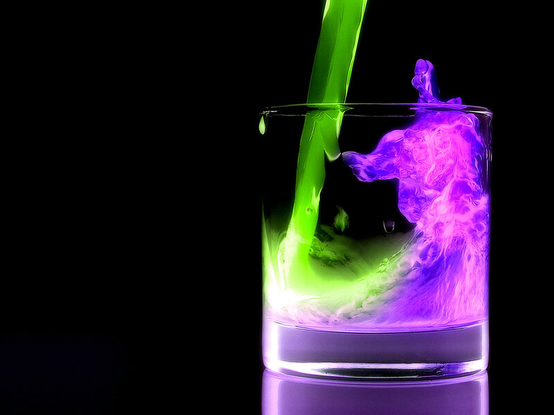 Colorful liquid pouring into glass