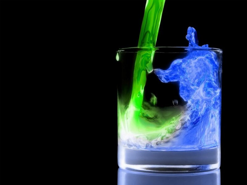 colorful liquid pouring into glass