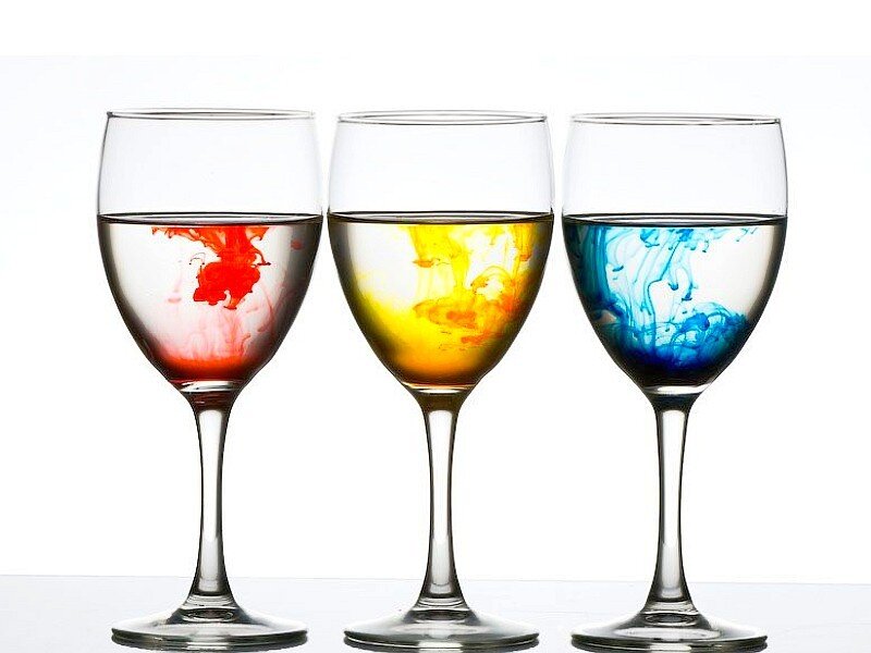 Colorful liquids in wine glasses
