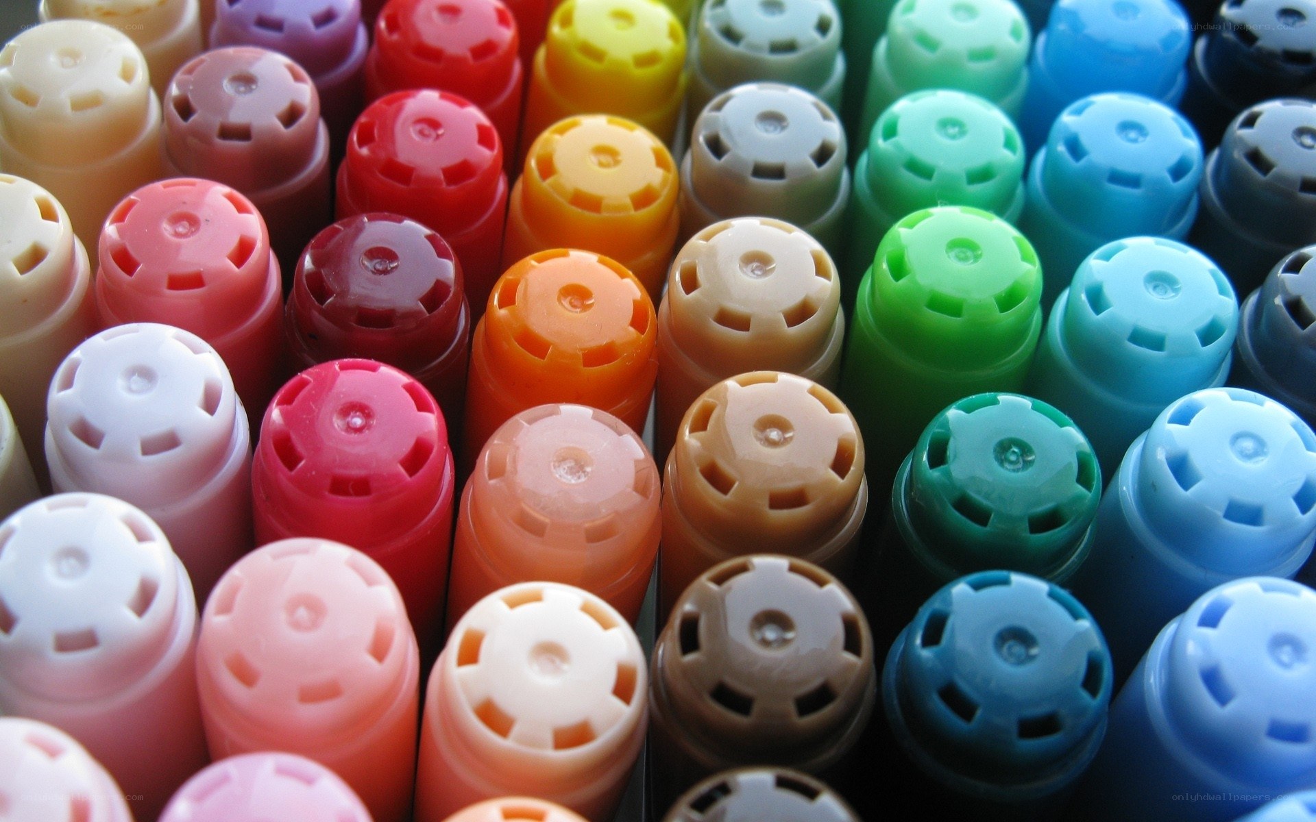 Colorful marker caps in rows
