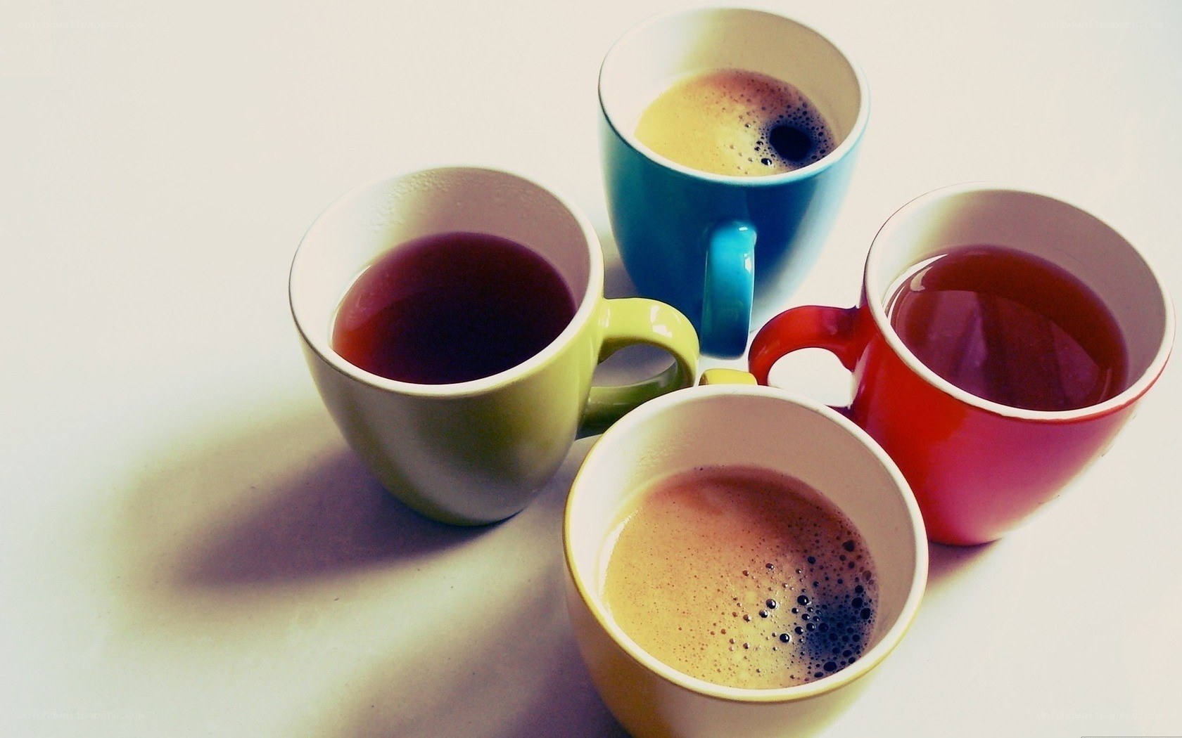 colorful mugs with hot drinks