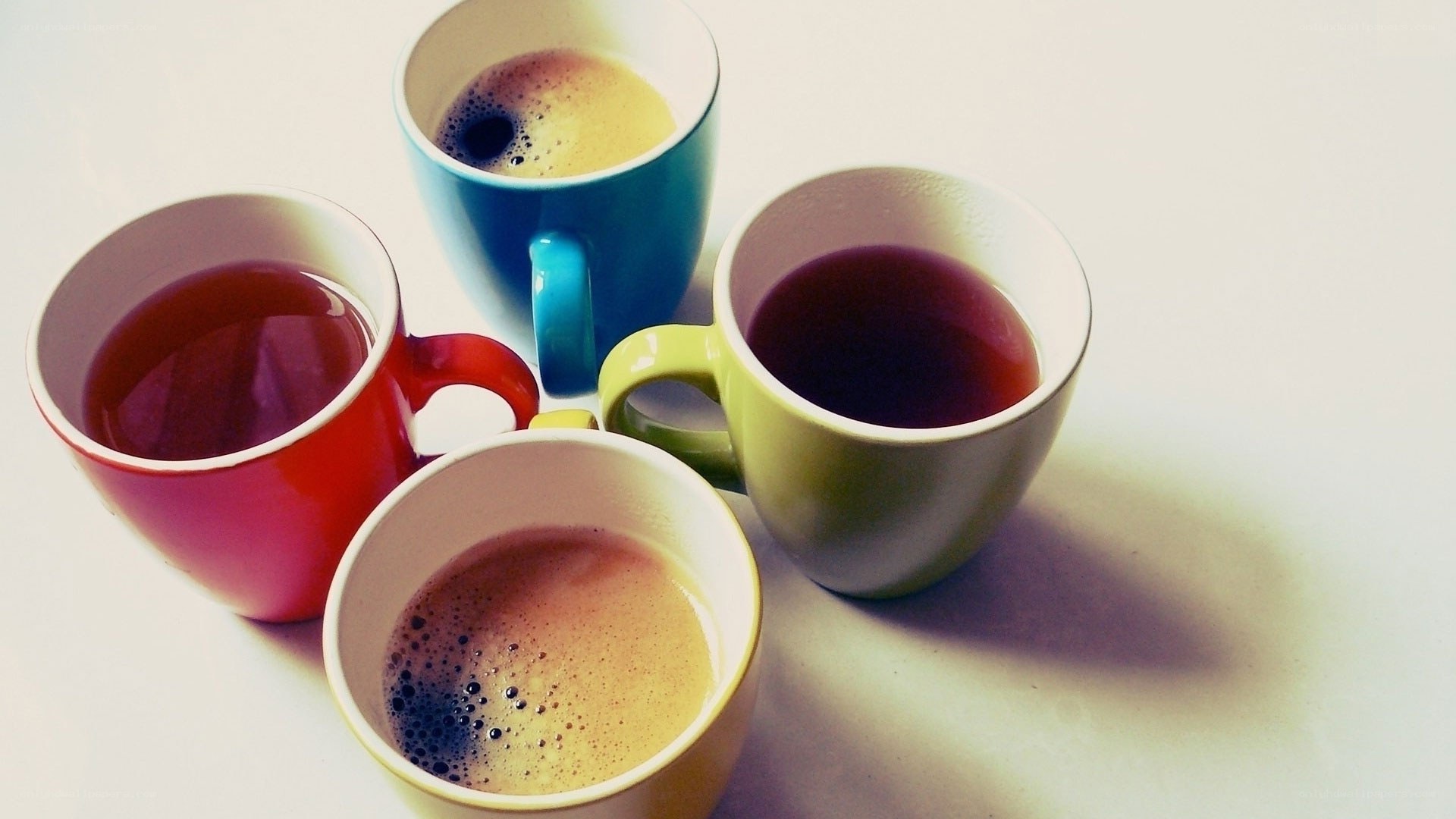 Colorful mugs with hot drinks