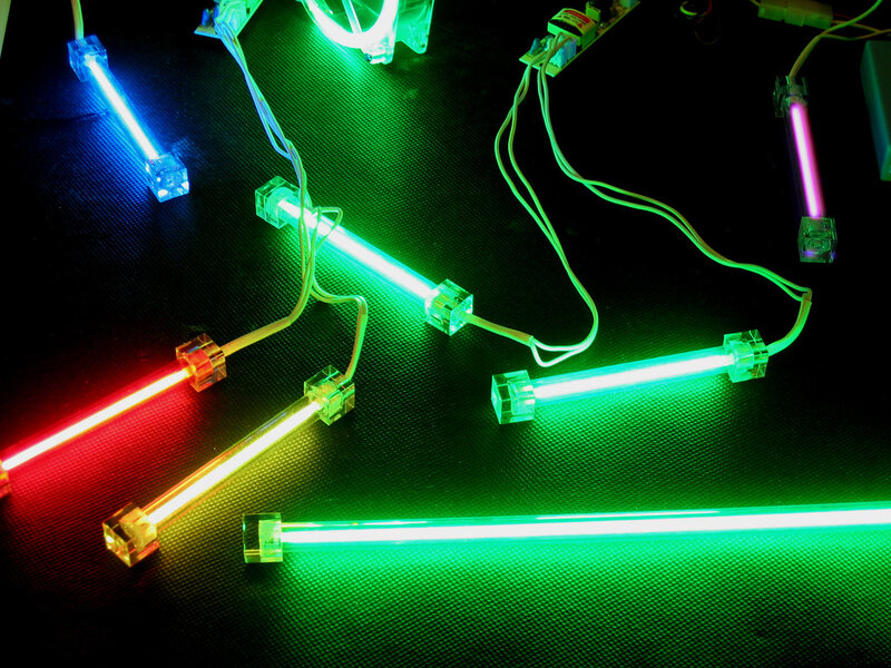 Colorful neon tubes on dark surface