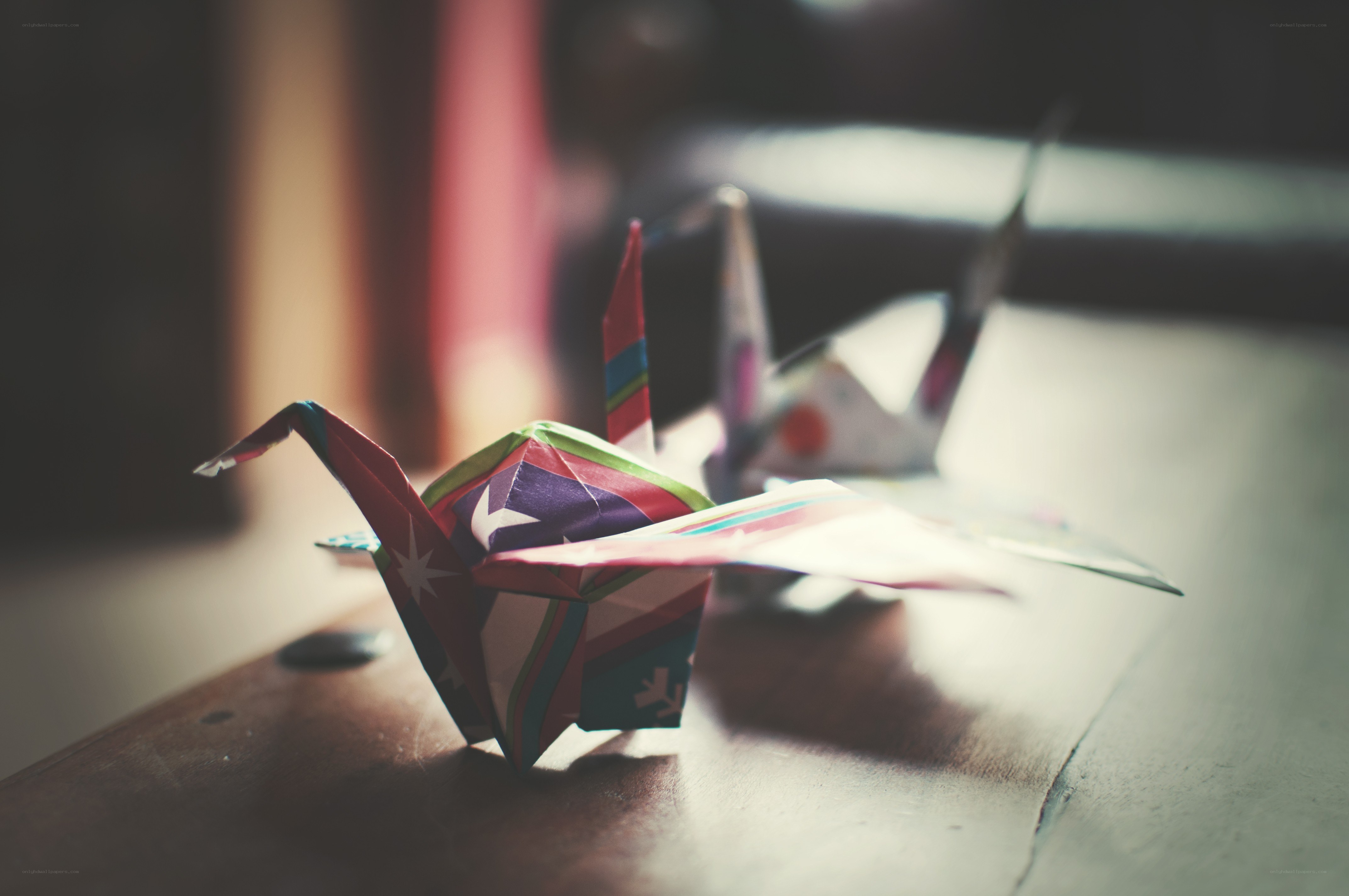 Colorful origami cranes on a table