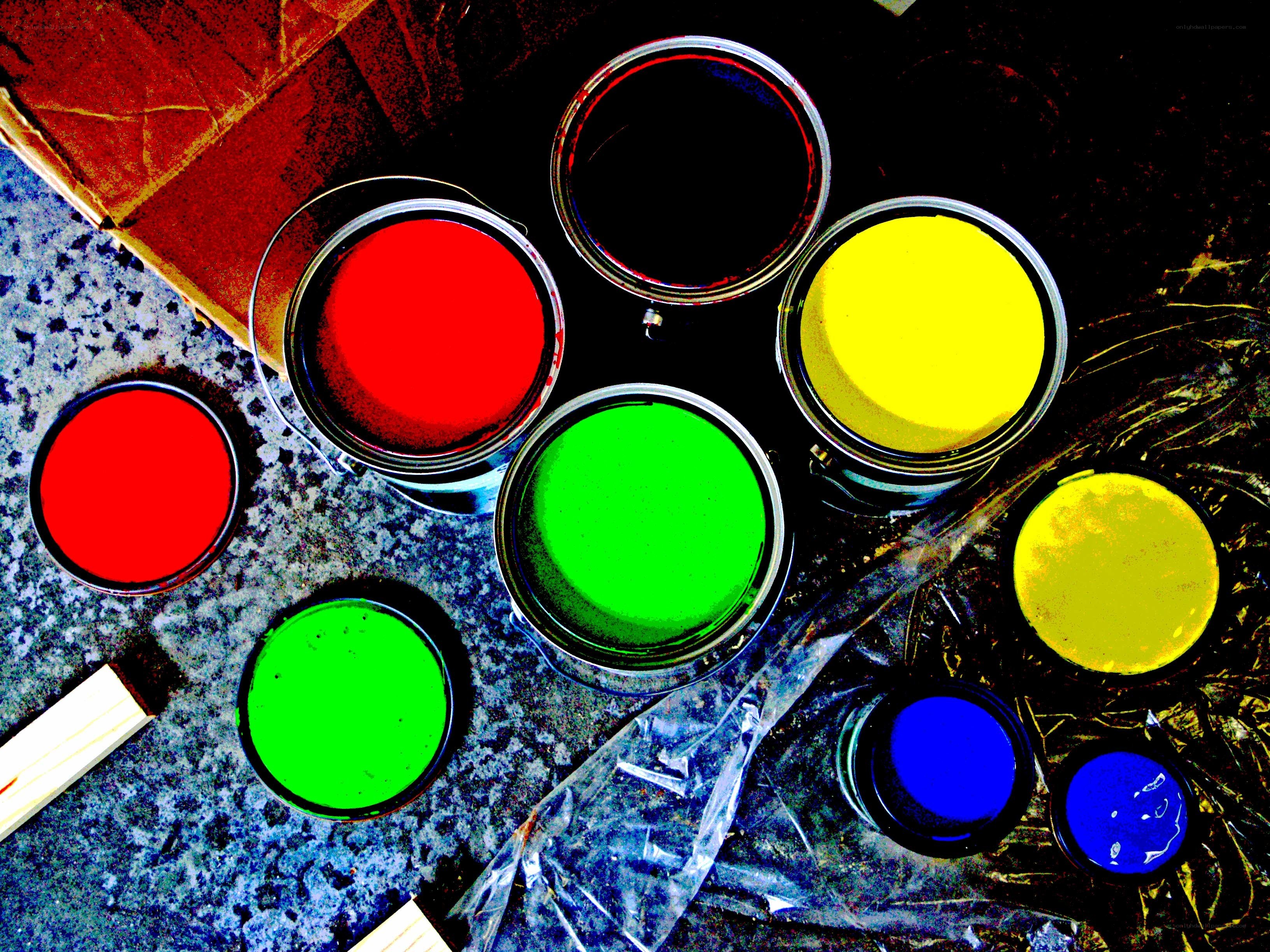 Colorful paint cans on a surface