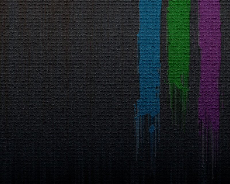 colorful paint drips on dark fabric