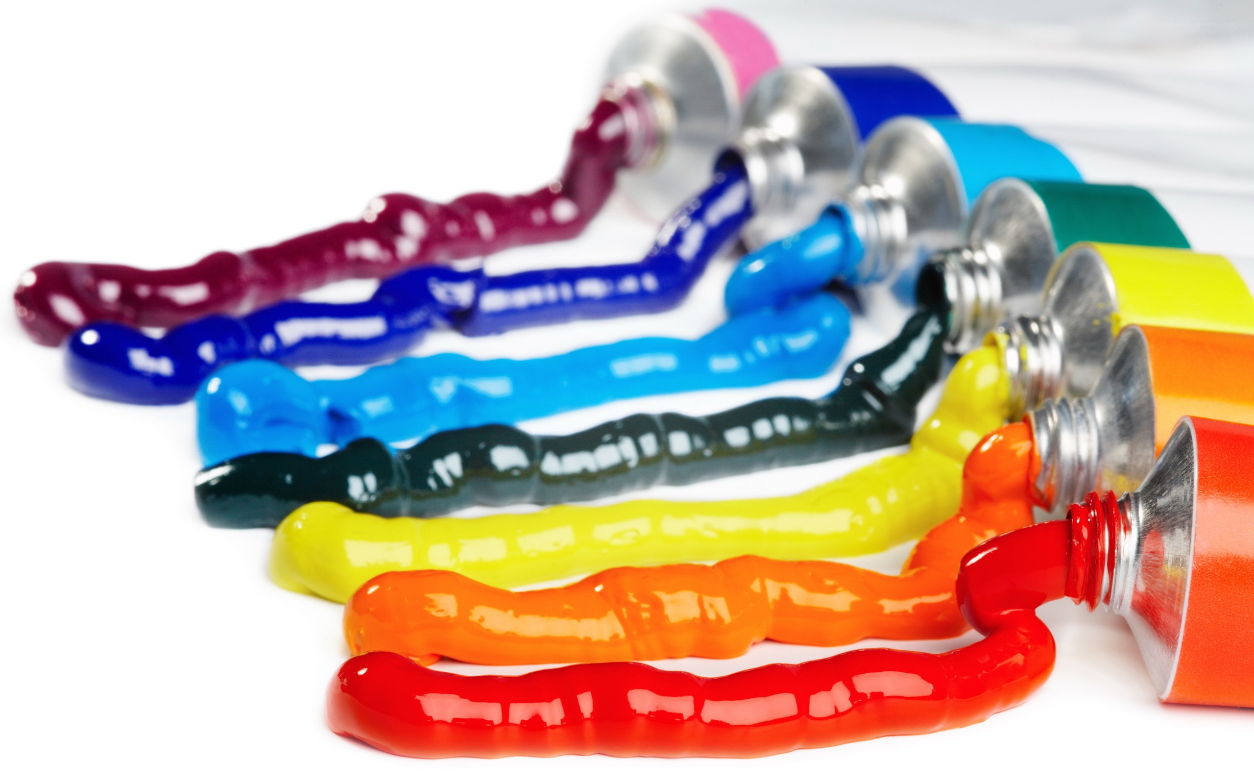 Colorful paint tubes on white