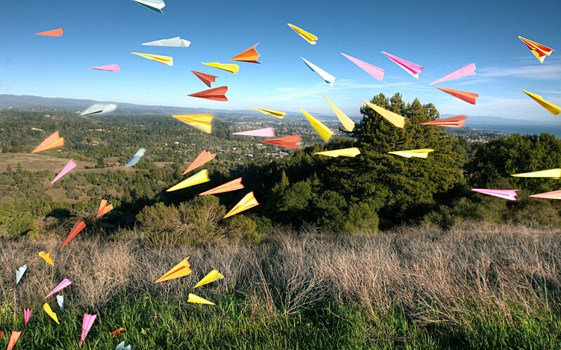 Colorful paper airplanes in flight