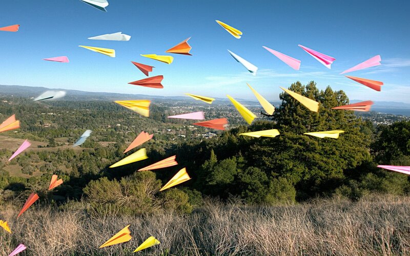 Colorful paper planes in flight