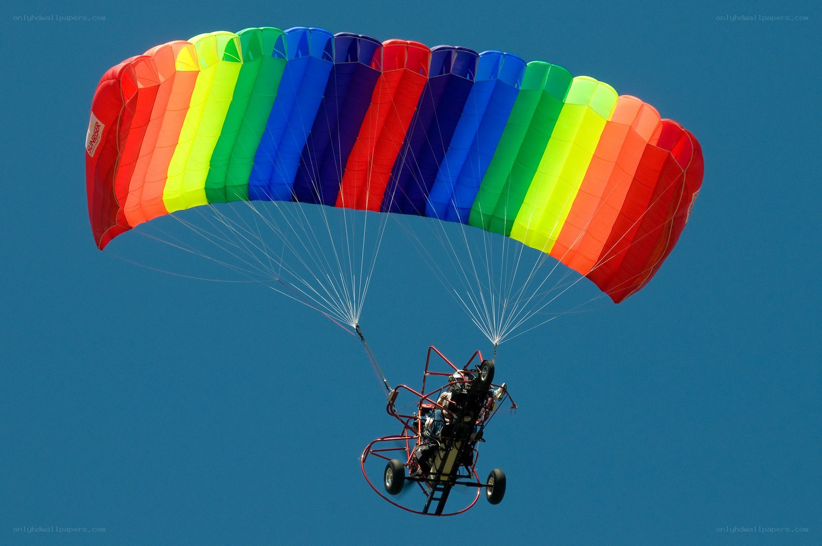 Colorful paraglider in flight