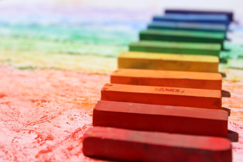 Colorful pastel crayons in rainbow order