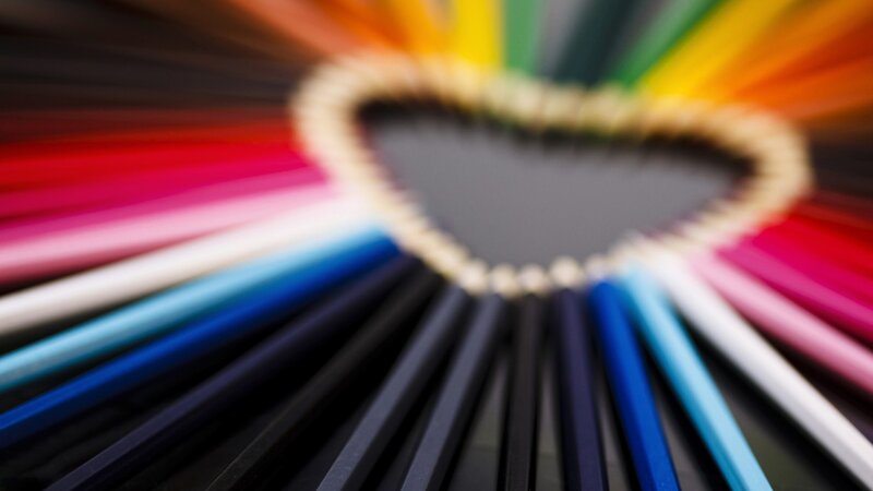Colorful pencils arranged in a heart