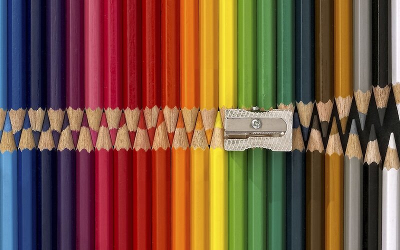 Colorful pencils arranged in rainbow