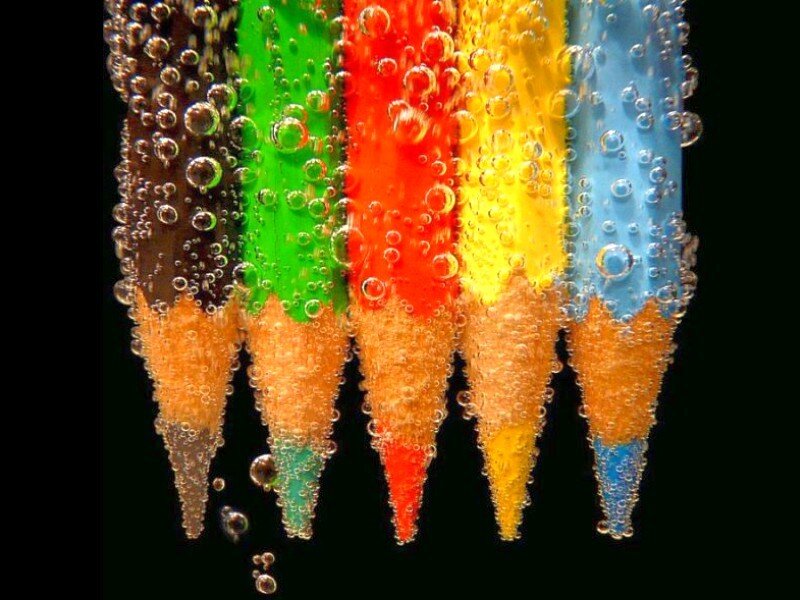 Colorful pencils in carbonated water