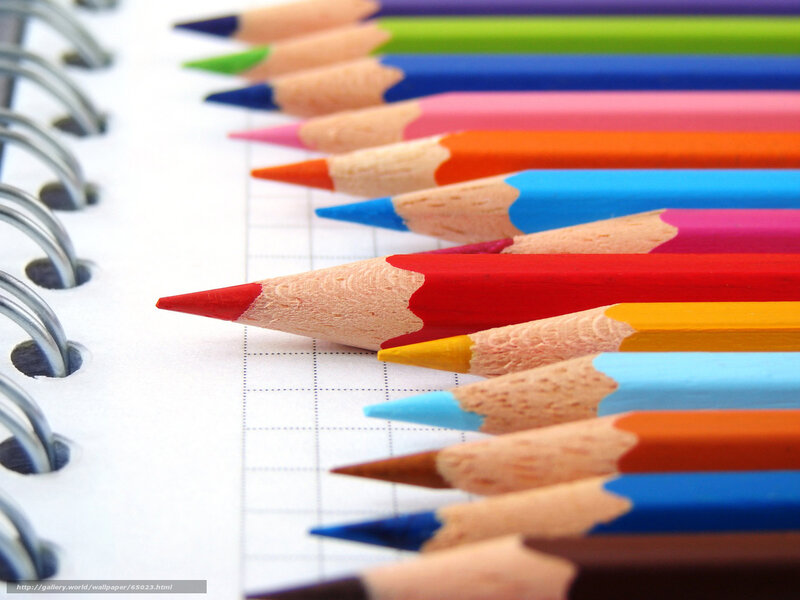 Colorful pencils on notebook
