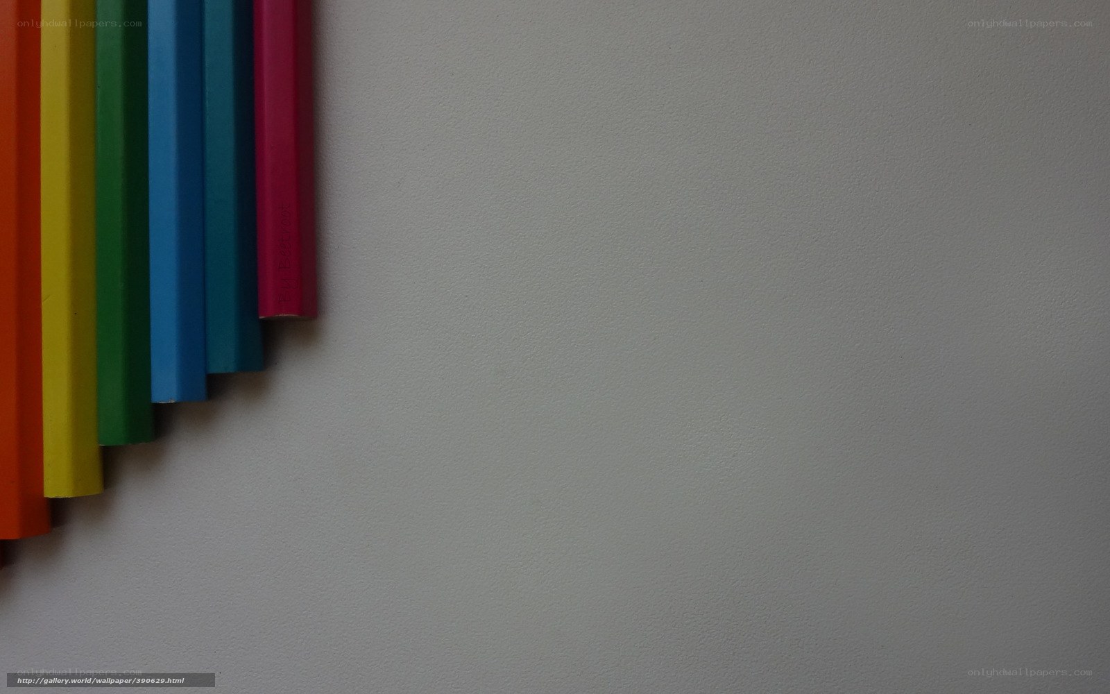 Colorful pencils on white surface