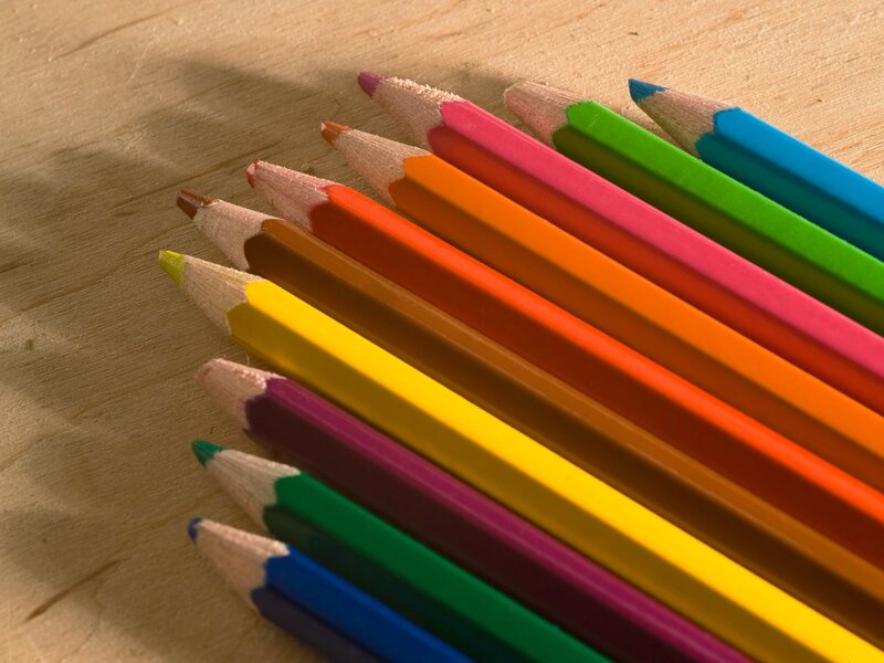 Colorful pencils on wood