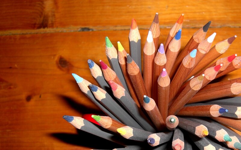 Colorful pencils on wood